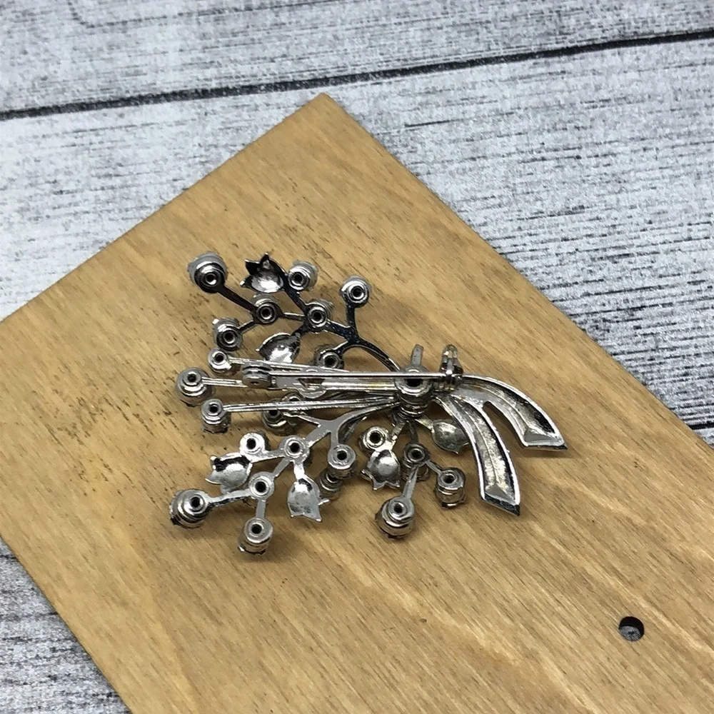 Vintage rhinestone flower branch statement glam brooch.